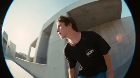 Young Skateboarder in a Black T-Shirt and Baggy Jeans
